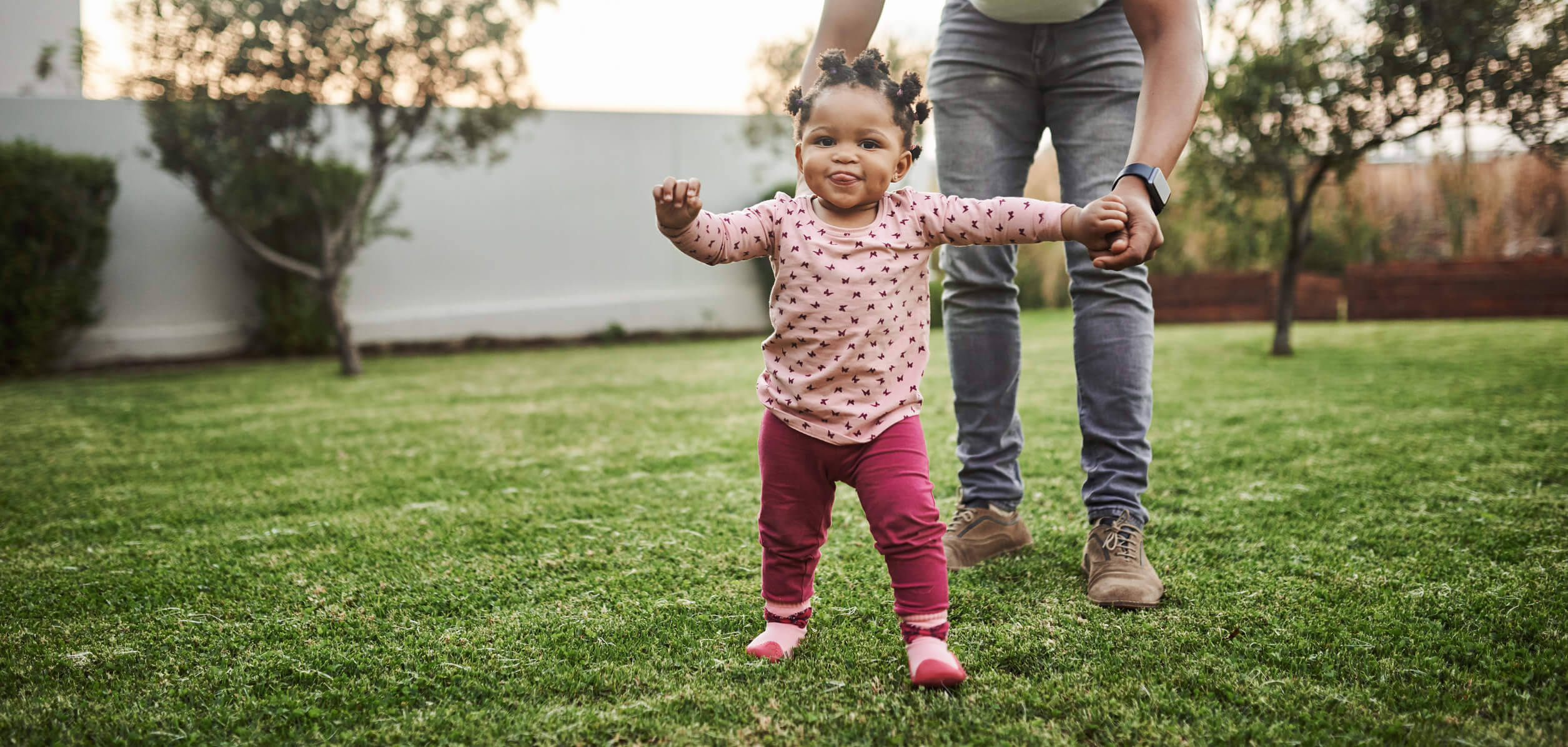 A child walking in the grass.